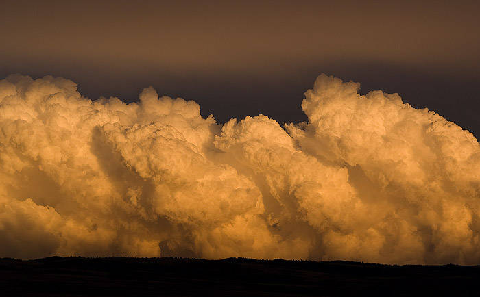 The fading evening light adds an eerie glow to a gathering thunderstorm over mountains east of Laramie.   Field Notes:  Sony...